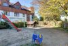 HTI | Attraktive, vermietete Dachgeschosswohnung in Feldrandlage von Liederbach - Spielplatz und Rückseite